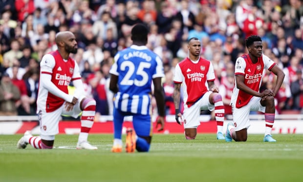 Arsenal and Brighton players take the knee before their Premier League game at the Emirates Stadium in April.