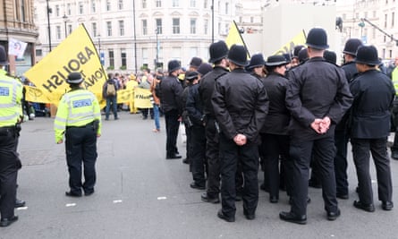 Police watch anti-monarchy protesters in Trafalgar Square