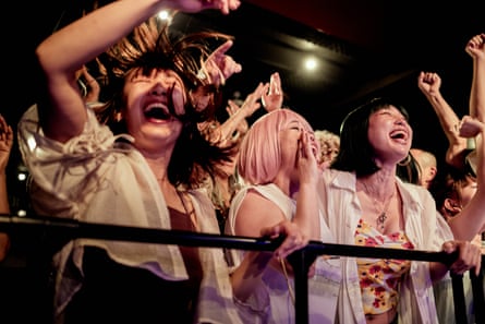 Audience at concert hall.The live audience waits for the artist to take the stage. Then, they cheer the stage.