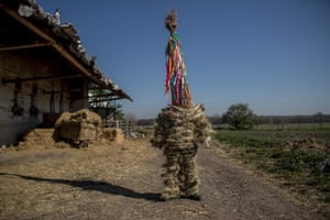 A boy dressed in a hay suit prepares for the Easter procession called Marching Judas in Stradouň, Czech Republic