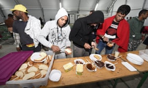 People arriving from Hungary are given food at a reception point in Nickelsdorf, Burgenland, Austria.