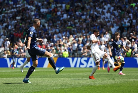 Edin Dzeko of Bosnia and Herzegovina shoots the ball as it is deflected off Sultan Albrake of Qatar for an own goal.
