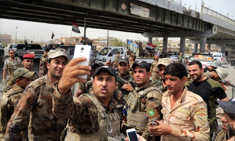 Iraqi security forces celebrate their victory in Falluja. 
