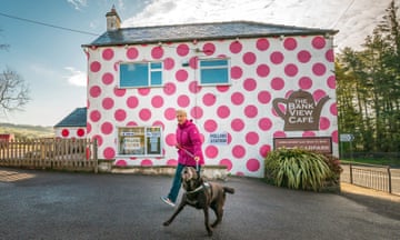 A woman and her dog outside a polling station in the Bank View Cafe, Sheffield, Yorkshire.