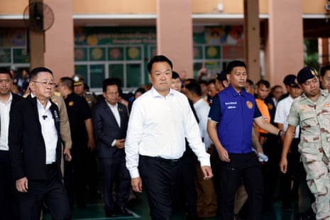 Thailand’s prime minister, Anutin Charnvirakul (C) arrives to inspect the site and talk to the media after the school shooting.