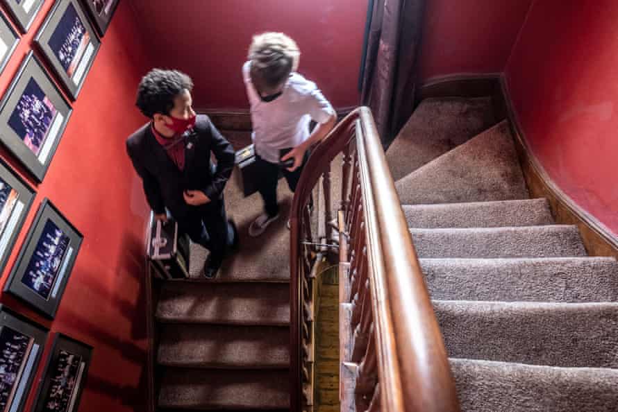 Magic students walk downstairs after class.