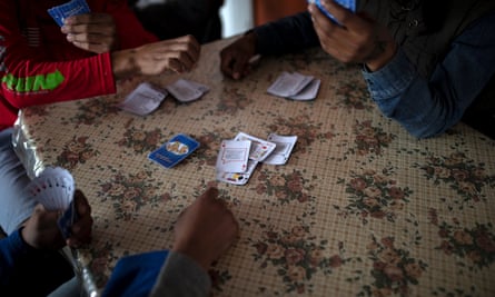 Teenage boys play a game of cards at a migrant shelter for unaccompanied minors in Tijuana, Mexico, 5 December 2018.
