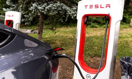 a tesla being charged at a Tesla charging point