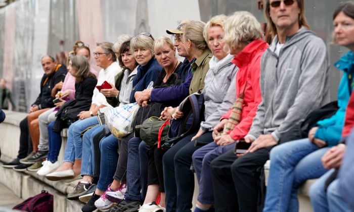 Members of the public in Whitehall, central London, ahead of the ceremonial procession of the coffin of Queen Elizabeth II.