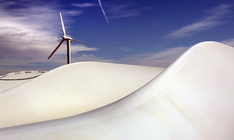 A wind turbine and, in the foreground, giant turbine blades, at the US-government-owned National Renewable Energy Laboratory on the outskirts of Boulder, Colorado