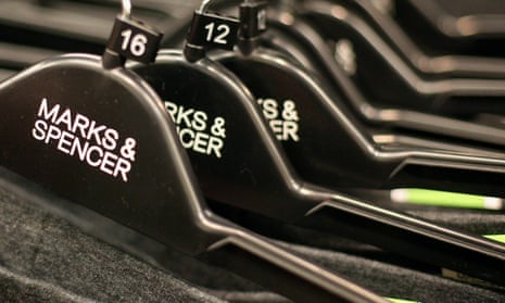 Clothes hangers are pictured in a Marks and Spencers retail store in Loughton, east of London. -