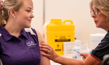 Nurse Keita Winks receives the Pfizer coronavirus vaccine in Perth on 22 February