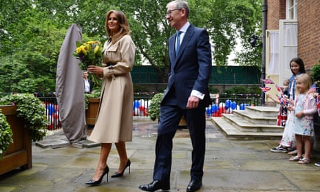 Melania Trump, complete with vertiginous heels, with Philip May at a Downing Street garden party. 