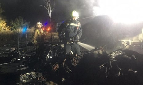 Rescuers workers after the Ukrainian military Antonov An-26 plane crashed near Kharkiv.