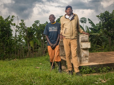 Clever Kadurira (on right, next to his older brother’s grave) with Celestin Musengimana (on left), who killed his brother during the Rwandan genocide