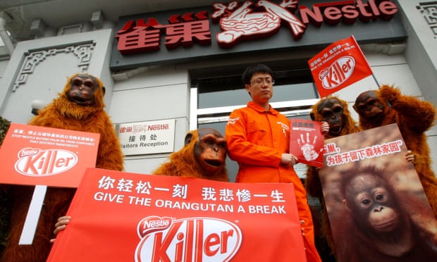 Greenpeace volunteers in orangutan costumes protest outside the offices of Nestlé in Beijing, March 2010
