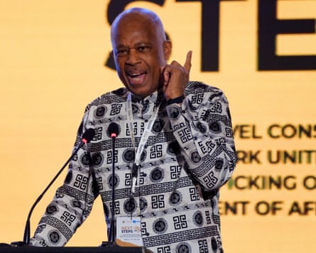 Beckles raises a finger in the air while speaking at a lectern