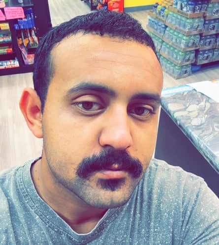 A man takes a selfie in a grocery store