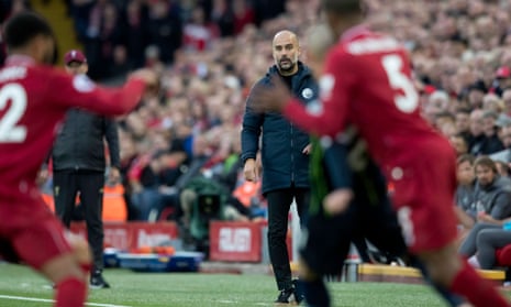 Pep Guardiola watches the action at Anfield.