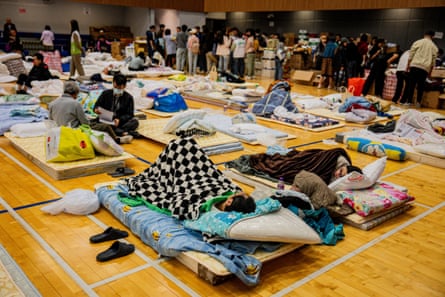 People affected by the fire resting at an emergency shelter.