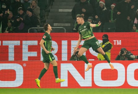 Dzenan Pejcinovic jumps in celebration with his teammate