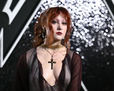 Singer Chappell Roan wearing a dark black dress and a large cross on a necklace