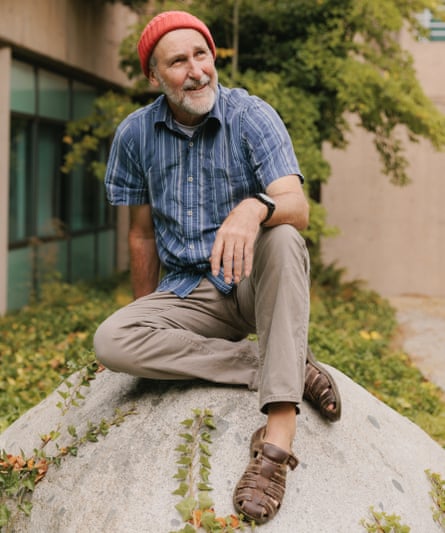 Angus Pratt, who is living with cancer, sitting on a rock