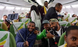 Passengers pose for a selfie onboard a flight from Addis Ababa to Asmara