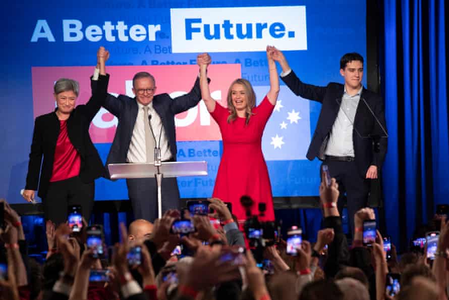 Anthony Albanese celebrates on-stage with his family and Penny Wong on election night 2021