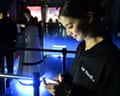 CES attendees use their cellphone lights to make there way out of the LG booth after a major blackout power outage.
