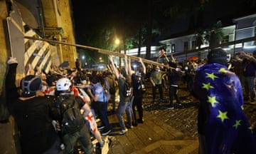 Demonstrators attempt to block the side entrance of the Georgian parliament during a rally on 1 May.