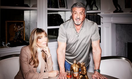 Flavin and Stallone at a table with a small statue of boxers.