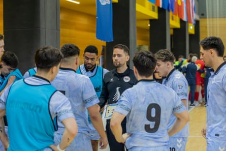 Rene Olsen, the coach, gathers his players.