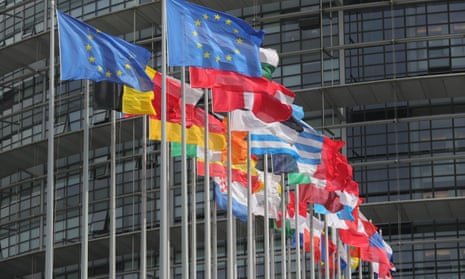Flags fly outside the European Parliament.