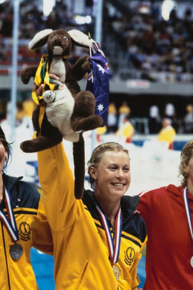 Swimmer Lisa Curry raises a Matilda mascot after winning a gold medal at the 1982 Commonwealth Games