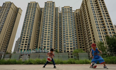 Children play in front of a housing complex in Beijing, July 2022.