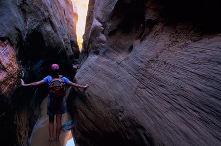 The writer, Annette McGivney, hikes in scoured-out narrows along Twilight Canyon at a location once 110 feet below the surface of Lake Powell.