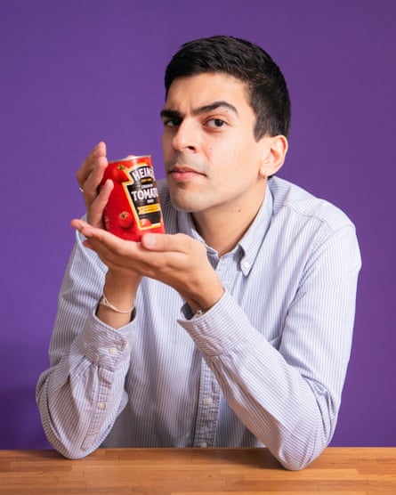 Ammar Kalia holding a can of Heinz cream of tomato soup