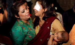 A woman injured in the bomb blast is comforted by a relative at a hospital in Lahore.