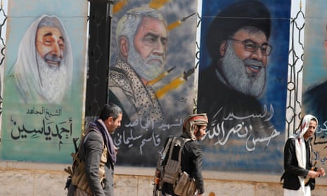 Houthis pass paintings depicting (from left) Hassan Nasrallah, Qassem Suleimani and Hamas late leader Sheikh Ahmed Yassin, at a street in Sana'a, Yemen, 03 January 2024. Yemen's Houthis have launched two anti-ship missiles targeting a cargo ship in the Red Sea, according to a statement by the Houthis military spokesman Yahya Sarea,EPA/YAHYA ARHAB