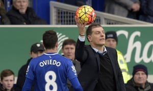 The West Ham manager, Slaven Bilic, catches the ball during the Premier League match against Everton