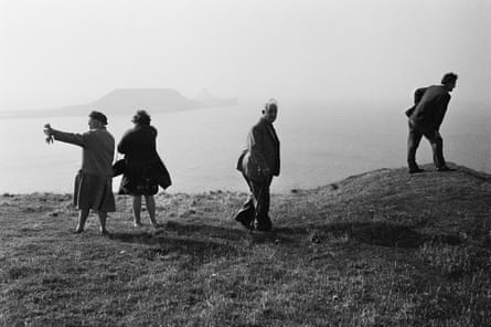 Black and white photograph of four people on top of a Welsh hilltop.