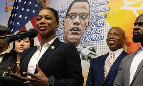 Keechant Sewell, who is to be New York police commissioner, speaks during a press conference earlier today in Queens. Behind her left elbow (smiling) is city mayor-elect Eric Adams and the mural depicts civil rights activist Malcolm X.