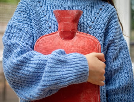 A girl holding a hot-water bottle