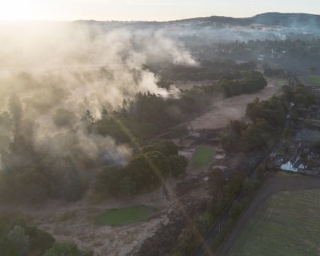 An aerial view shows burnt houses as the wildfire continues to spread to the golf course in Stourbridge, England.