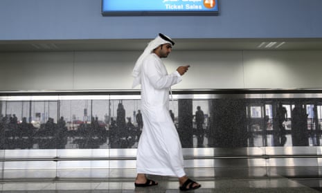A man uses his phone at the airport in Dubai, United Arab Emirates. 
