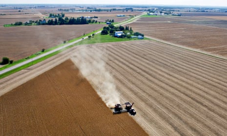 Soybeans are harvested by a combine harvester on a farm near Peru, Illinois.
