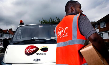 A Virgin Media employee delivering a digital tv reciever.