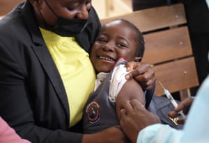 Harare, Zimbabwe: a girl smiles as she is vaccinated against measles at a clinic