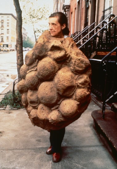 Louise Bourgeois, pictured 1975, wearing her latex sculpture Avenza (1968–69), which became part of Confrontation (1978).